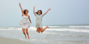 Myrtle Beach Photographers at the Beach capture the "Myrtle Beach Jump" with two wonderful young ladies at a family photo shoot. 