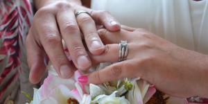 Myrtle Beach Photographers at the Beach capture newlyweds wedding rings over the brides beautiful bouquet.